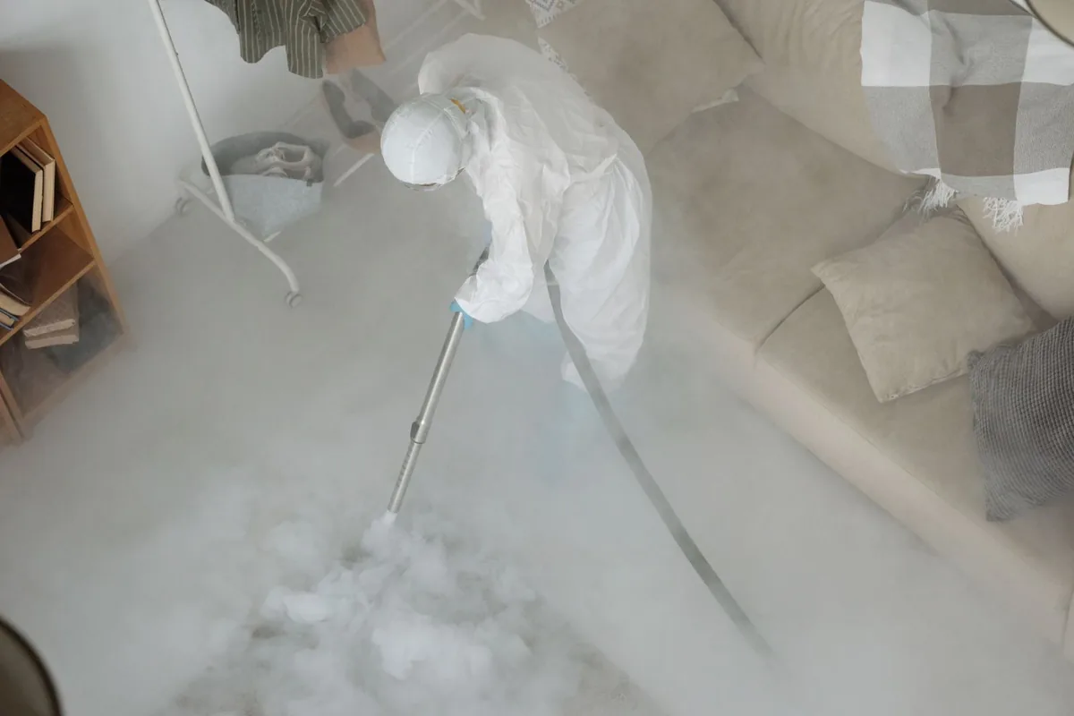 Biohazard cleanup technician in protective equipment, Livermore Falls, ME